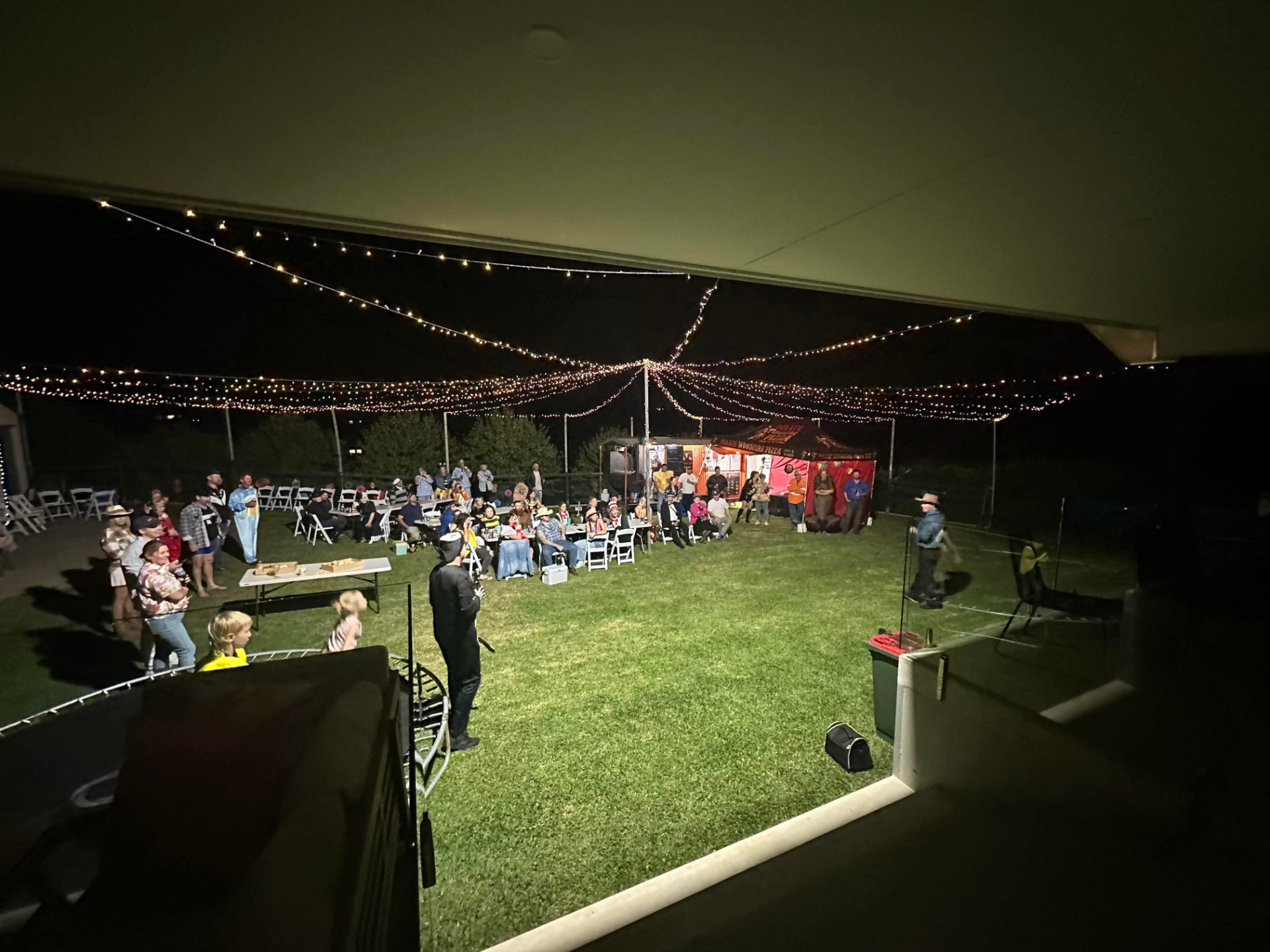 Pirate Woodfire Eats catering an evening event under string lights