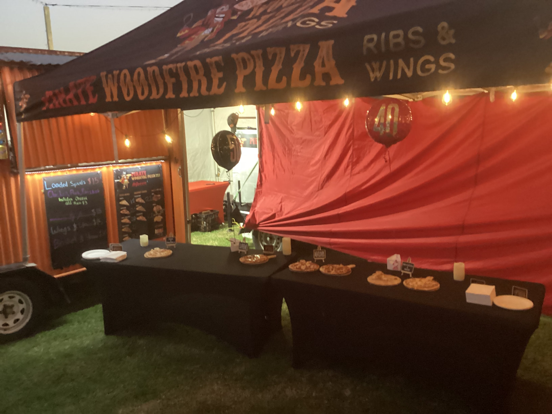 Wood-fired pizzas served from the trailer at an evening event