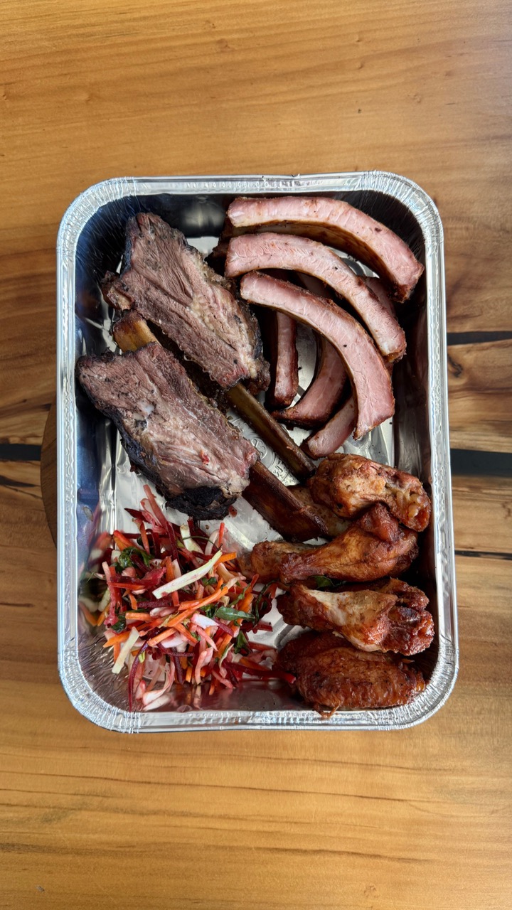 Tray of smoked ribs, wings and slaw